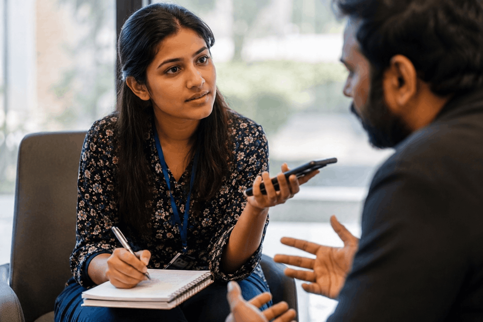 "Journalism student taking notes during interview - arts career path"